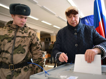 A woman votes in Russia's presidential election in Moscow on March 15, 2024. (Photo b