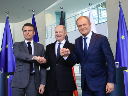 Emmanuel Macron, France's president, left, Olaf Scholz, Germany's chancellor, and Donald T