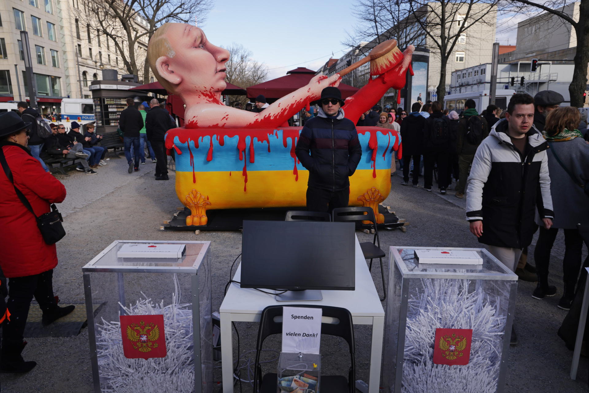 BERLIN, GERMANY - MARCH 17: Mock voting urns with shredded ballots stand in front of an effigy of Russian President Vladimir Putin bathing in the blood of Ukraine at a protest outside the Russian Embassy during Russian elections on March 17, 2024 in Berlin, Germany. Presidential elections in Russia, which are taking place without any meaningful opposition candidates allowed, will conclude today with President Vladimir Putin all but certain to be reelected. (Photo by Sean Gallup/Getty Images)