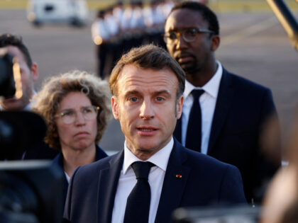 French President Emmanuel Macron, next to France's Deputy Minister for Overseas Territorie