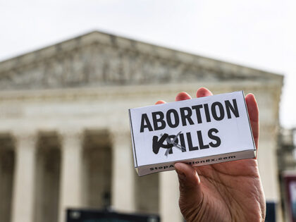 A demonstrator outside the US Supreme Court in Washington, DC, US, on Tuesday, March 26, 2