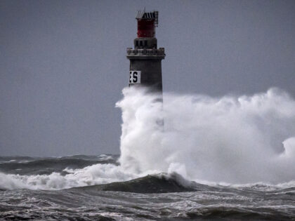 Waves crash against the Phare des Barges lighthouse during storm Nelson, in Les Sables-d&#