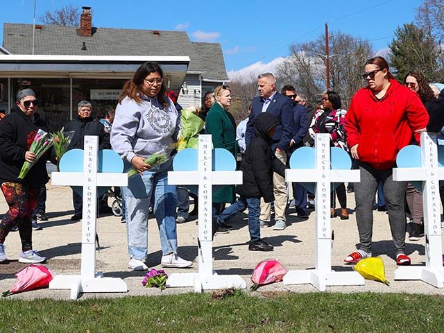 Community members gather at a vigil to remember victims of a recent deadly stabbing attack