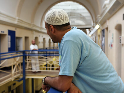A Muslim inmate on the balcony outside his cell in Wandsworth prison. HMP Wandsworth in So