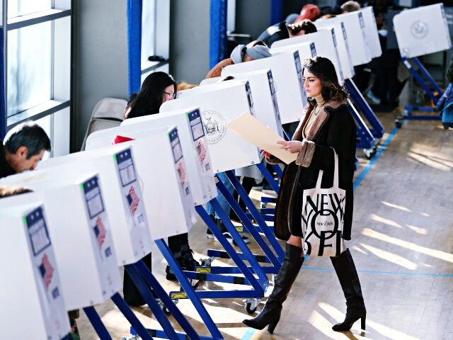 NEW YORK, Nov. 8, 2016 -- A voter walks to a booth to fill in her ballot at a polling stat