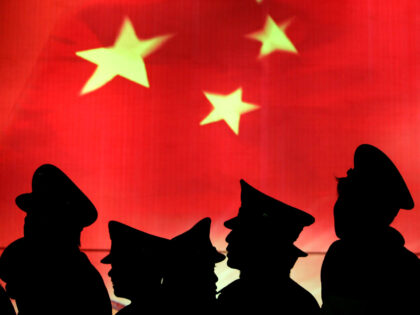 BEIJING, CHINA - MARCH 1: (CHINA OUT) Security guard walk past the Chinese national flag a