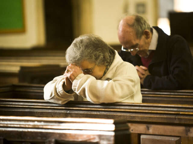 People pray inside St. Mary the Virgin church in Thornbury, South Gloucestershire, as the