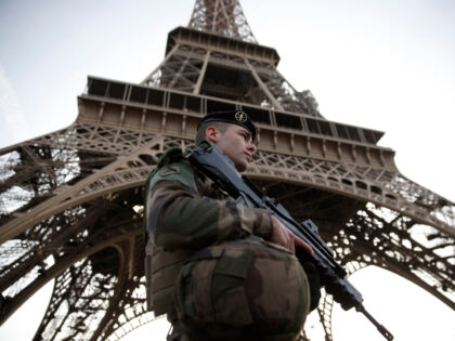 A French soldier, part of the "Operation Sentinelle", patrols in front of the Eiffel Tower