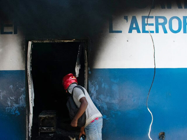 A man looks inside the burned police station "Commissariat de l'Aeroport" i