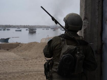 An Israeli soldier looks over the main port of Gaza in November 2023 during a battle in wh