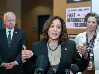 Vice President Kamala Harris speaks to the media after touring Planned Parenthood, behind