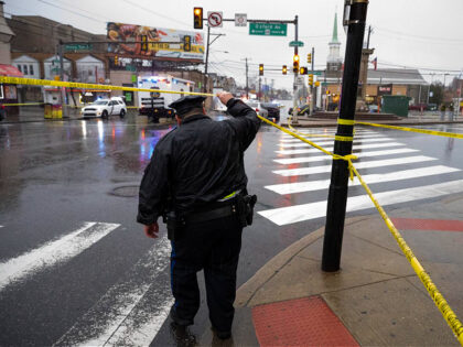 An officer works on scene following a shooting in Northeast Philadelphia on Wednesday, Mar
