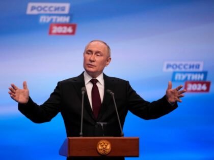Russian President Vladimir Putin speaks on a visit to his campaign headquarters after a pr