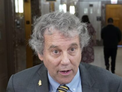 Sen. Sherrod Brown, D-Ohio, talks with reporters before a Senate Banking Committee hearing
