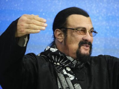Steven Seagal, the American action-movie actor who also holds Russian citizenship gestures