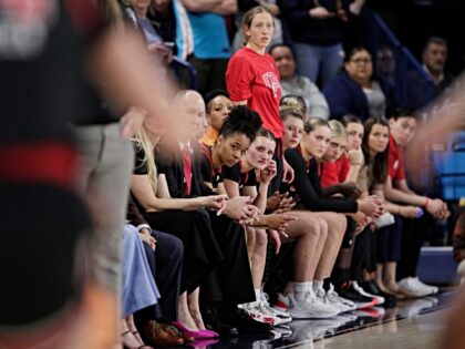 Players and staff on the Utah bench react toward the end of a second-round college basketb
