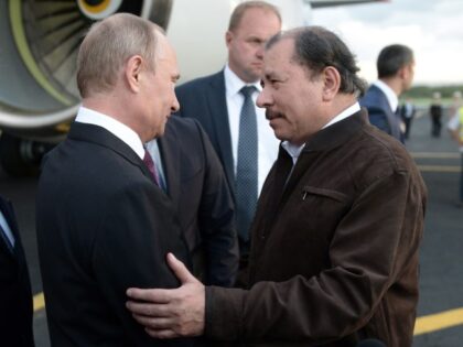Nicaragua's President Daniel Ortega, right, greets Russian President Vladimir Putin u