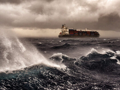 A cargo ship sails on the Mediterranean sea during a thunderstorm some 20 naughtical miles