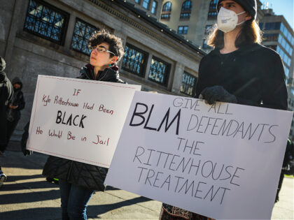 Boston, MA - November 20: Demonstrators attend a small protest in Boston on Nov. 20, 2021