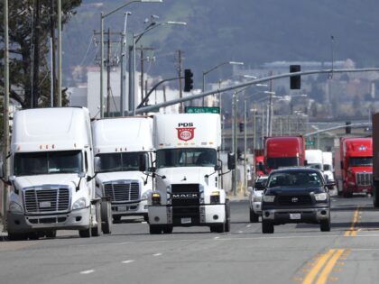 OAKLAND, CALIFORNIA - MARCH 31: Trucks drive through the Port of Oakland on March 31, 2023