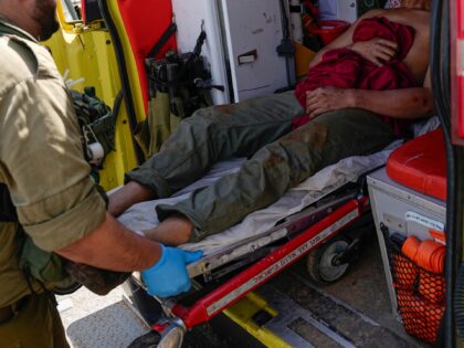 Israeli security forces in Kiryat Shoma, northern Israel, evacuate a wounded Thai man afte