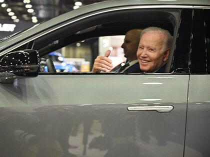 US President Joe Biden sits at the wheel of a Cadillac Lyriq electric vehicle as he visits