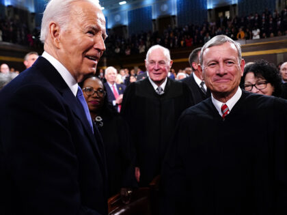US President Joe Biden, left, greets John Roberts, chief justice of the US Supreme Court,
