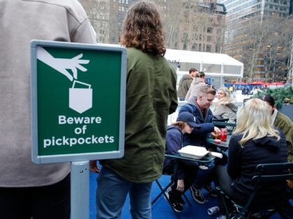 A sign reading "Beware of pick pockets" is seen as people visit the Winter village in Brya