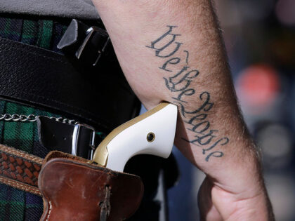 In this Jan. 26, 2015 file photo, a supporter of open carry gun laws, wears a pistol as he