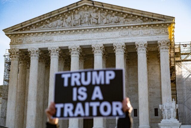 Anti-Trump demonstrators protest outside the US Supreme Court as the court considers wheth