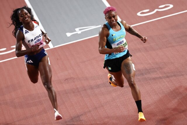 First-placed Bahamas' Devynne Charlton (R) crosses the finish line in the world indoor 60m