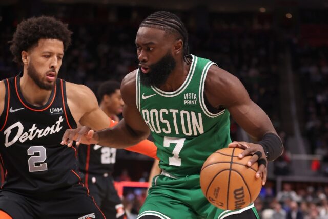 Boston's Jaylen Brown drives around Cade Cunningham in the Celtics' NBA victory over the D