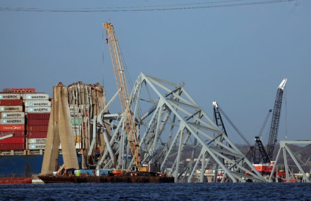 Cranes work to clear debris from the Francis Scott Key Bridge on March 29, 2024 in Baltimo