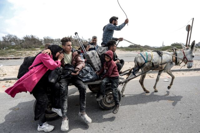 Displaced Palestinians arrive at the Nuseirat refugee camp in central Gaza after fleeing f