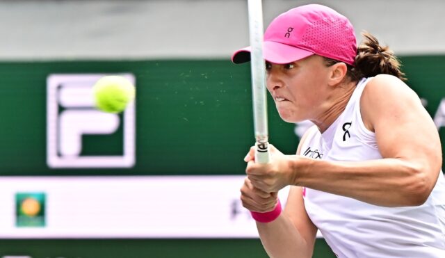 World number one Iga Swiatek hits a backhand on the way to victory over Greece's Maria Sak