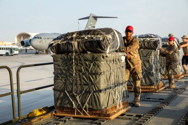 In this image obtained from the US Central Command, military personnel load humanitarian a