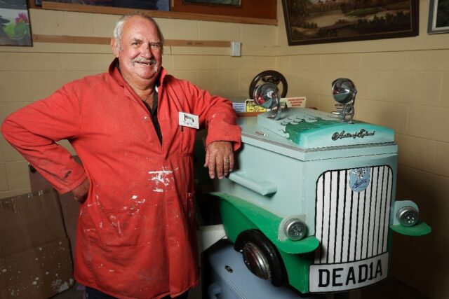 Kevin Heyward poses next to his Austin car coffin that he made at the Coffin Club’s work