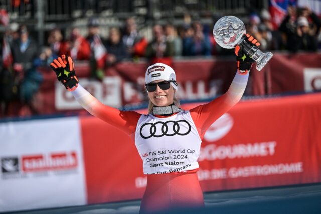 Lara Gut-Behrami celebrates with the overall trophy after Sunday's giant slalom