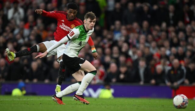 Manchester United substitute Amad Diallo (L) scores the winning goal against Liverpool in