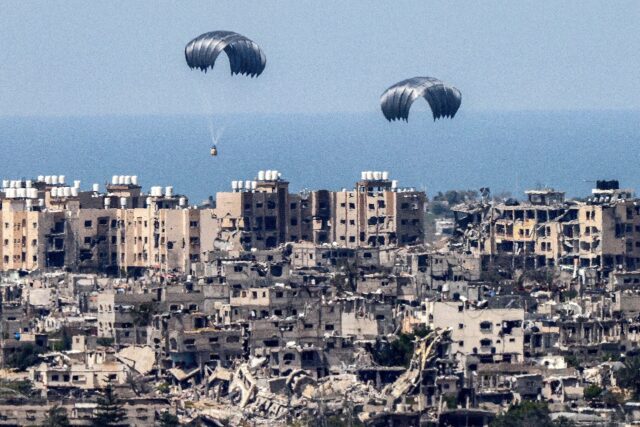 This picture taken from Israel's southern border with the Gaza Strip shows parachutes of h