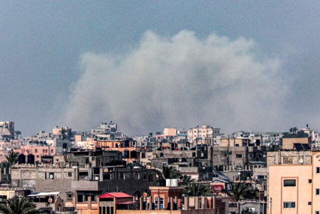 A picture taken from Rafah shows smoke billowing over Khan Yunis in the southern Gaza Stri