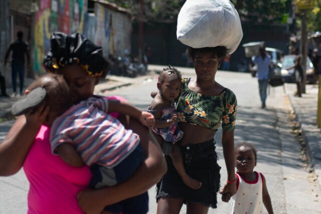 Residents flee their homes as gang violence escalates in Port-au-Prince, Haiti, on March 9