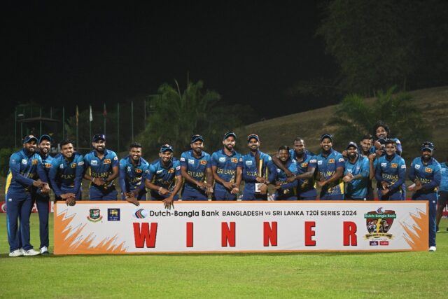 Sri Lanka's cricketers pose with the Twenty20 trophy after winning the three-match series