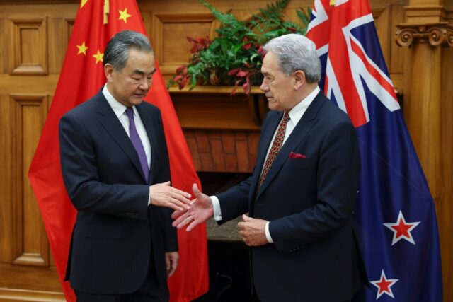 New Zealand Minister of Foreign Affairs Winston Peters (R) shakes hands with Chinese count