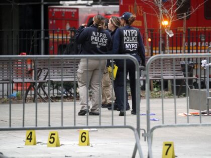 Police inspectors gather evidence around a park outside of Manhattan Criminal Court where