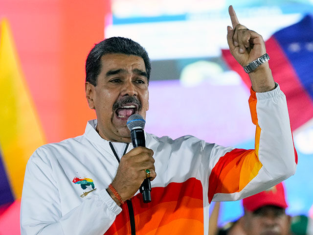 President Nicolas Maduro speaks to pro-government supporters after a referendum regarding