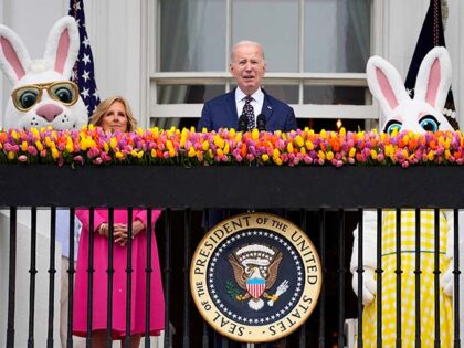 President Joe Biden speaks as first lady Jill Biden looks on at the White House Easter Egg