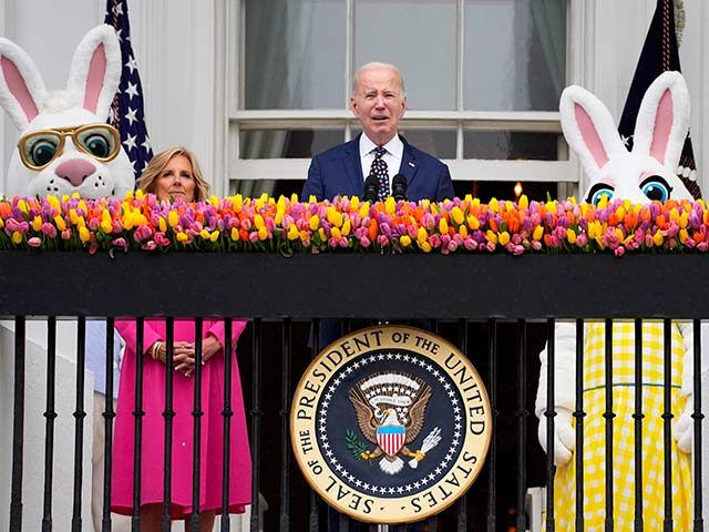 President Joe Biden speaks as first lady Jill Biden looks on at the White House Easter Egg