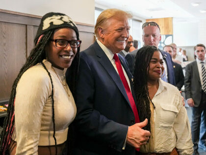 Republican presidential candidate former President Donald Trump, center, takes a photo wit