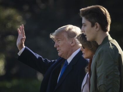 US President Donald Trump, first lady Melania Trump, and Barron Trump walk across the Sout